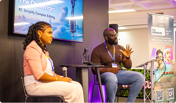 Yoma speaking on stage at a business event
