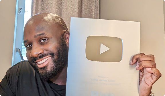 Yoma holding his YouTube creator award