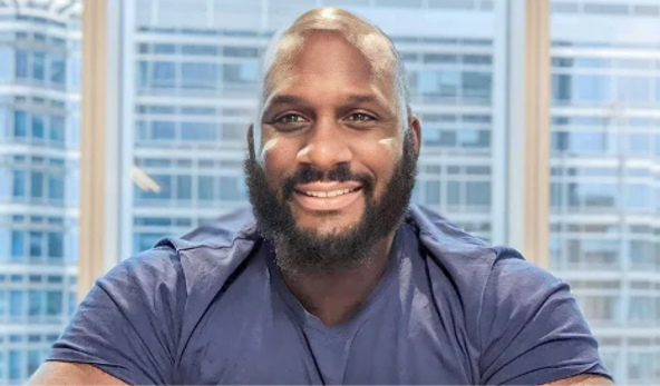 Yoma James Kukor smiling in his office